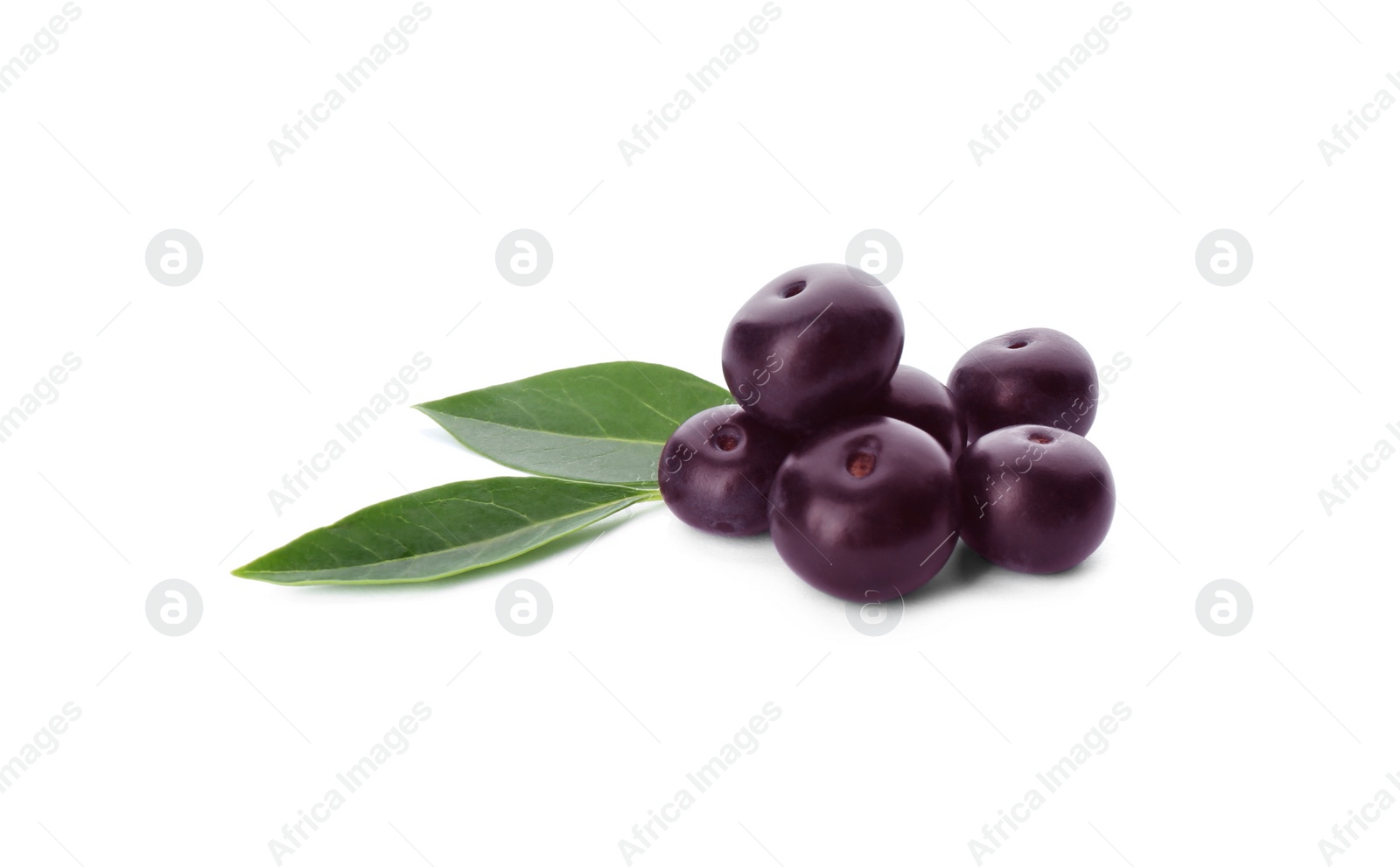 Photo of Pile of fresh acai berries with leaves isolated on white