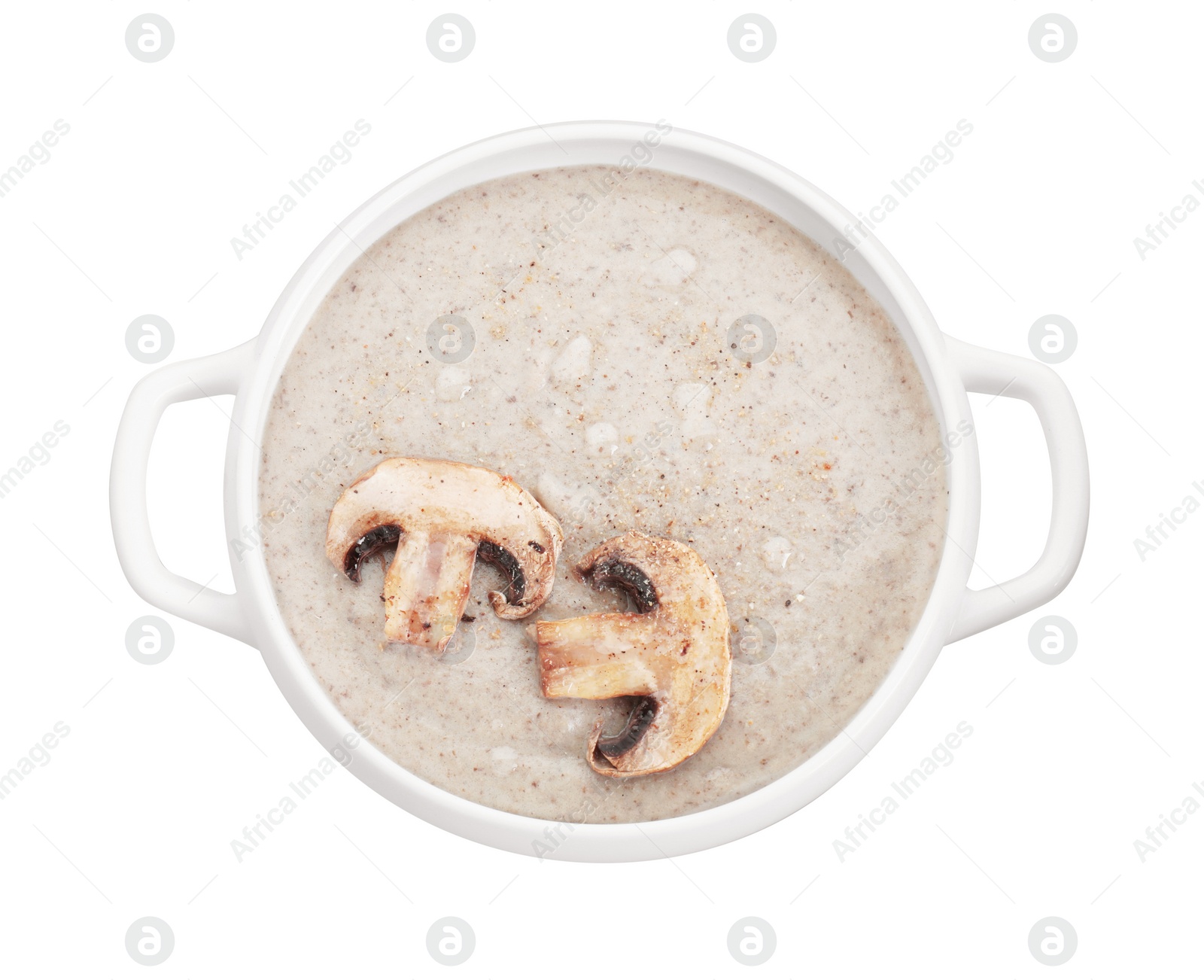 Photo of Delicious mushroom cream soup in bowl isolated on white, top view