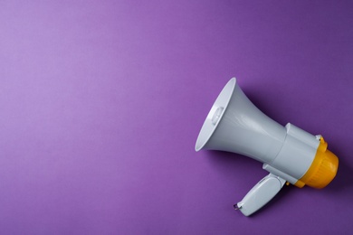 Electronic megaphone on color background