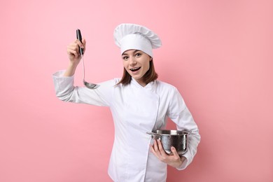 Photo of Professional chef cooking pot and ladle on pink background