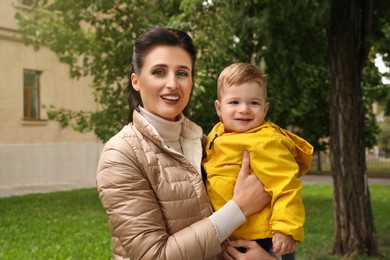 Photo of Portrait of happy mother with her son in park