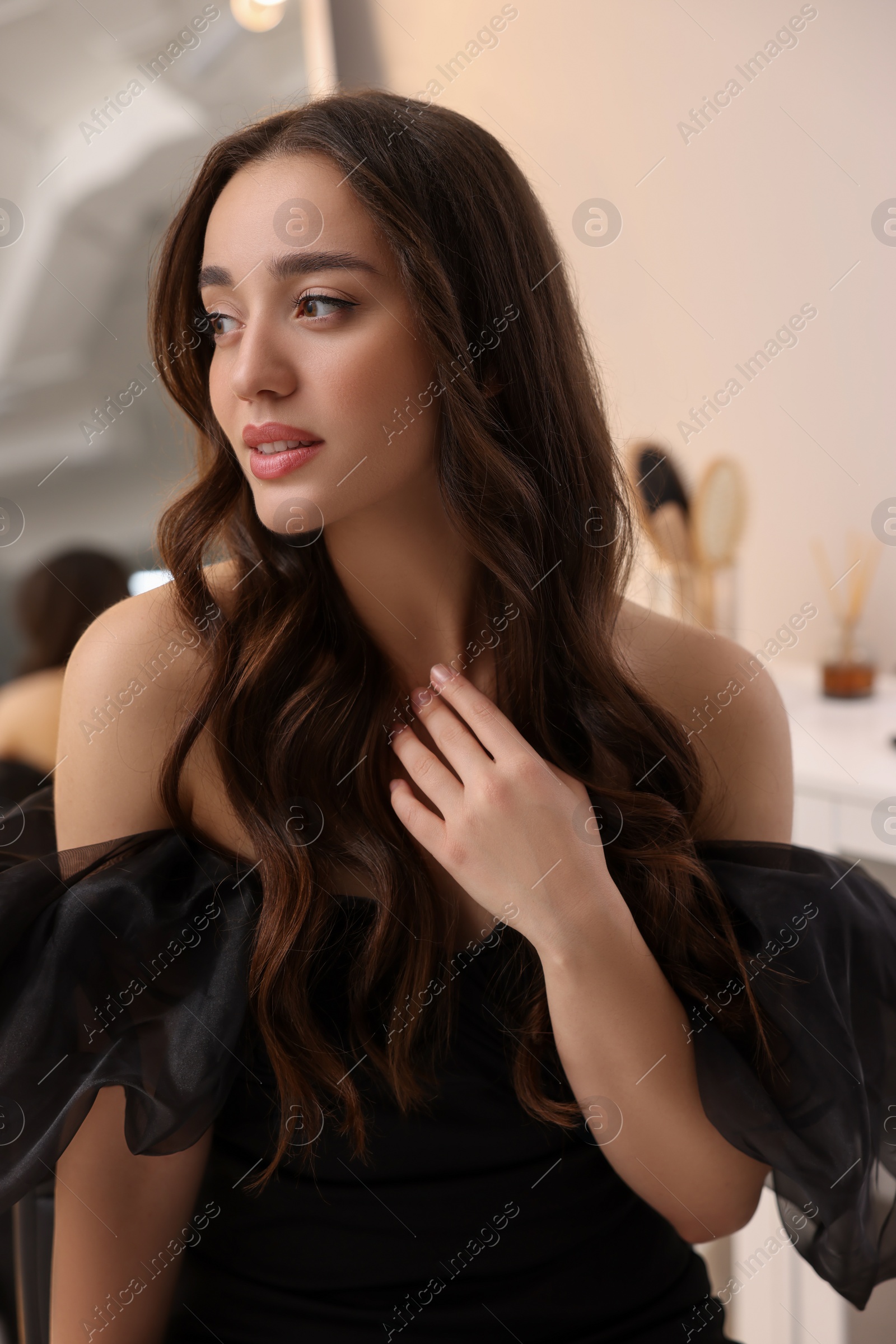 Photo of Portrait of beautiful woman with curly hair indoors