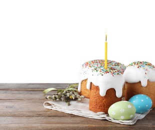 Photo of Easter cakes and painted eggs on wooden table against white background. Space for text