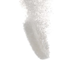 Effervescent pill dissolving in water on white background, closeup