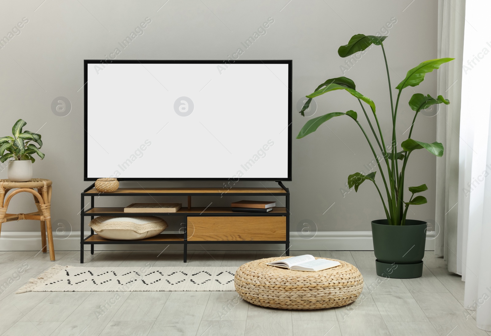 Image of Modern TV set on stand in room