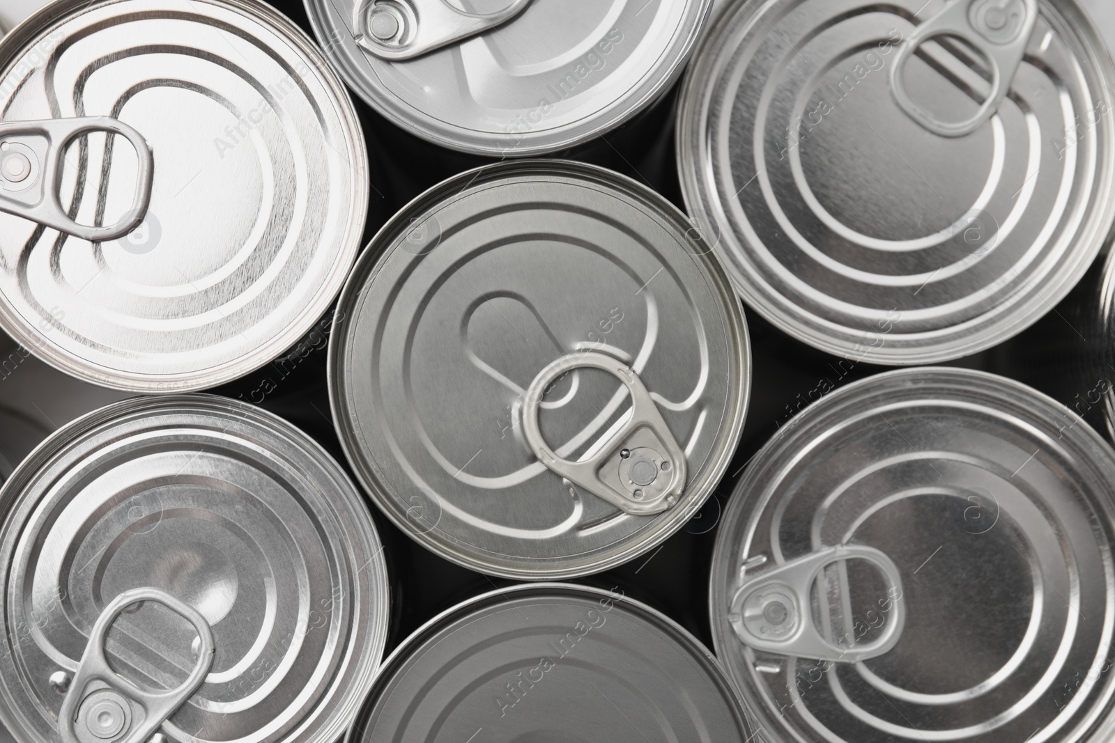 Photo of Many closed tin cans as background, top view