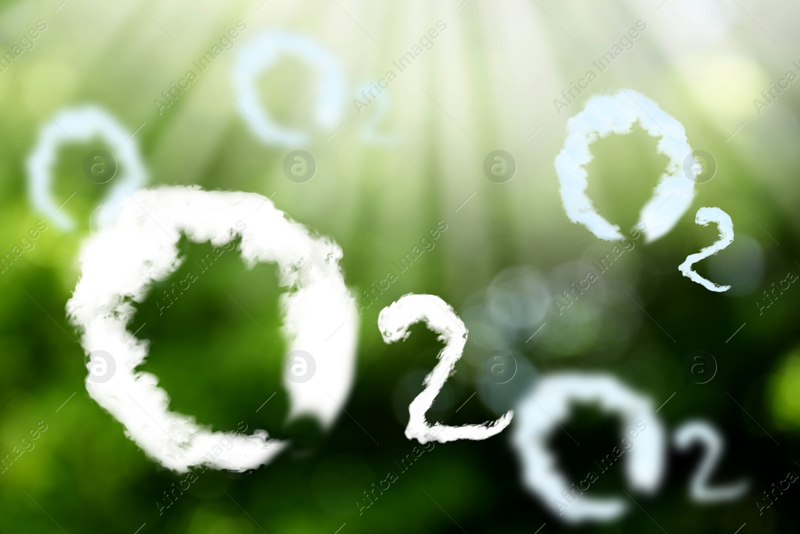 Image of O2 molecules made with clouds and blurred view of green background. Oxygen release concept