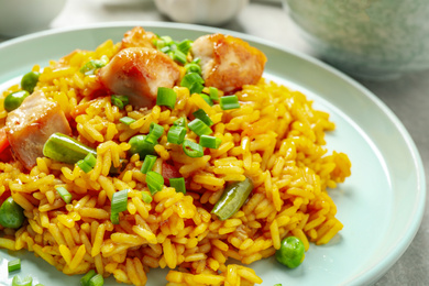 Photo of Delicious rice pilaf with vegetables and chicken on plate, closeup