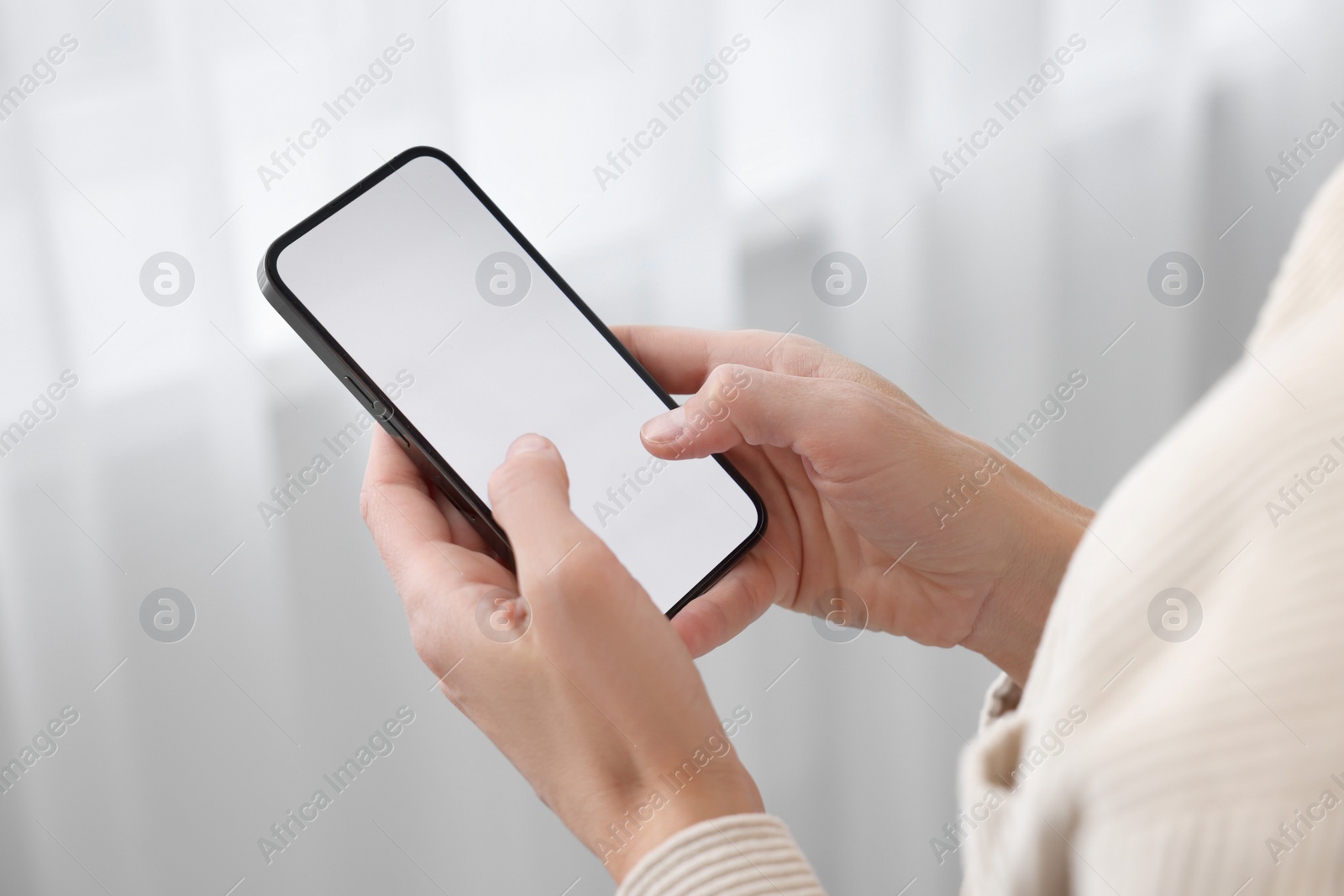 Photo of Woman using smartphone at home, closeup. Space for text