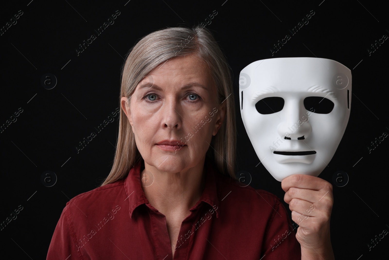 Photo of Multiple personality concept. Woman with mask on black background