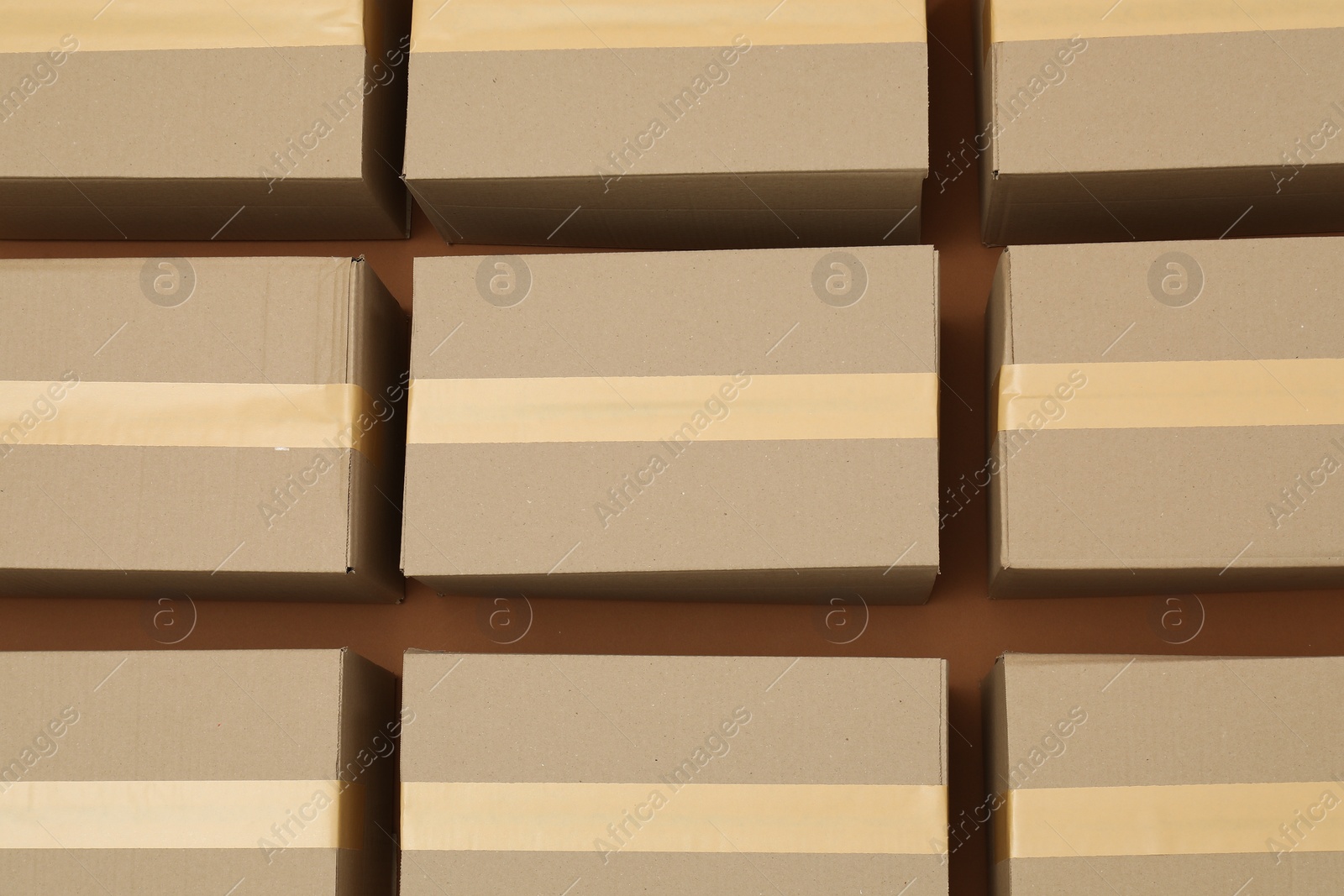 Photo of Many cardboard boxes on brown background, flat lay