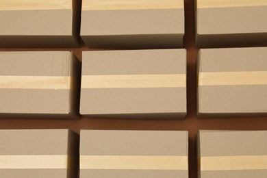 Photo of Many cardboard boxes on brown background, flat lay