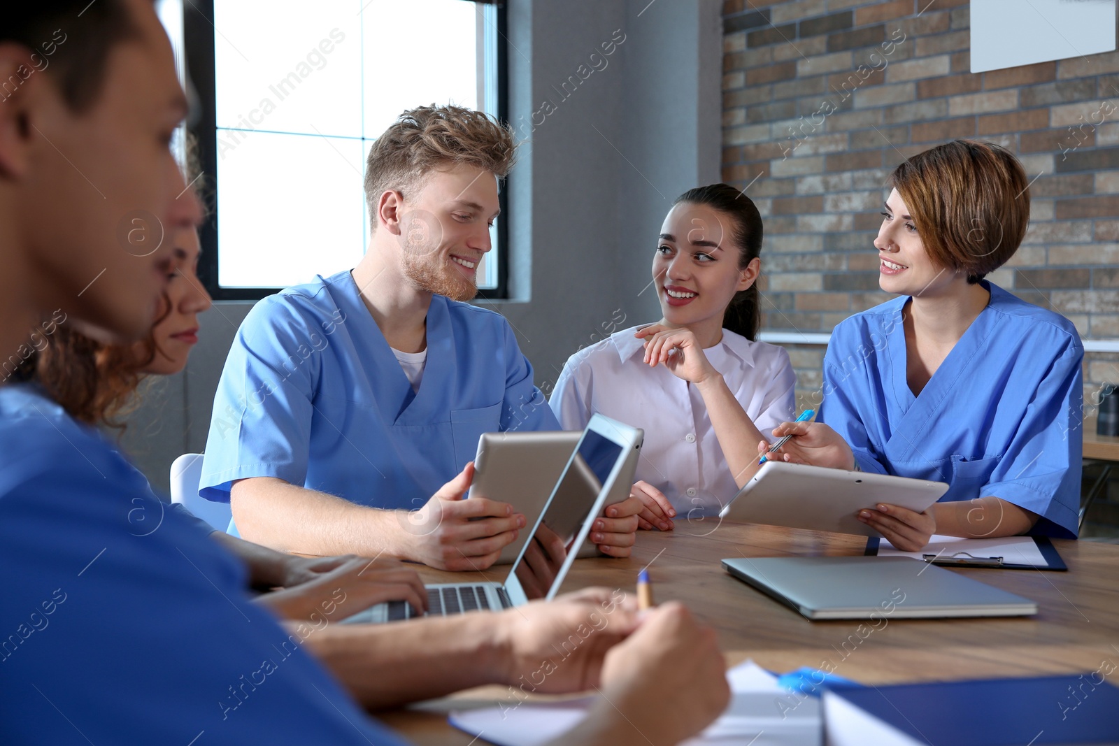 Photo of Group of smart medical students with gadgets in college