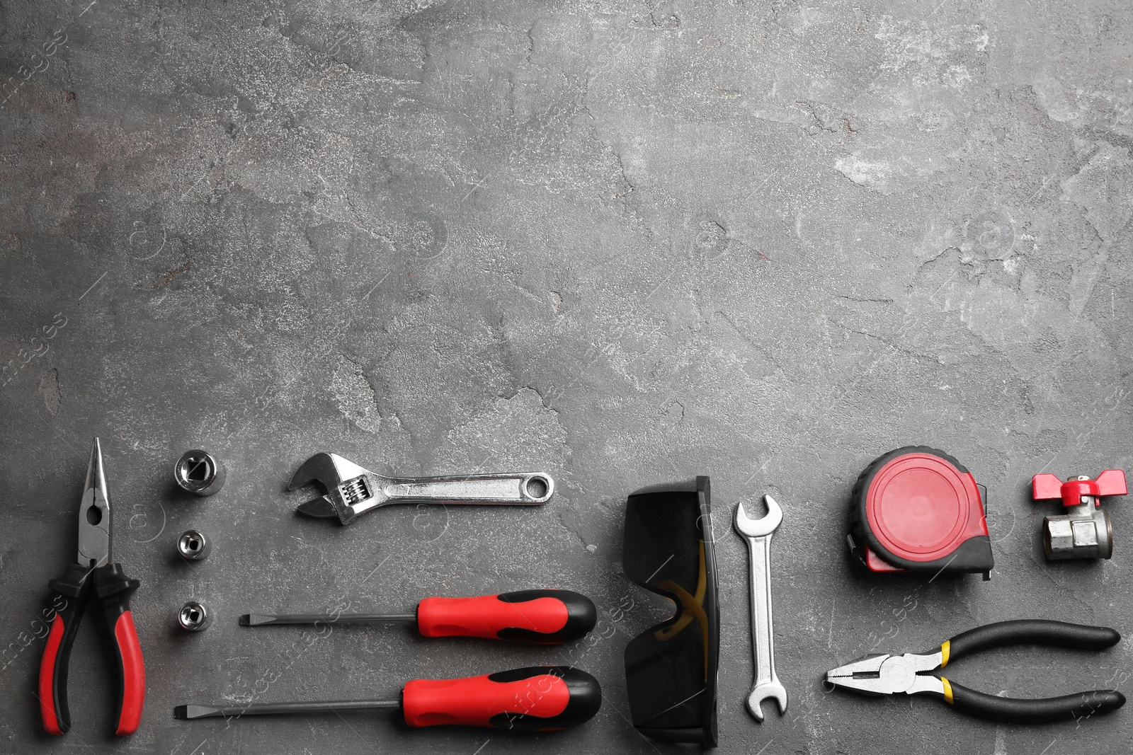 Photo of Flat lay composition with construction tools on grey background, space for text