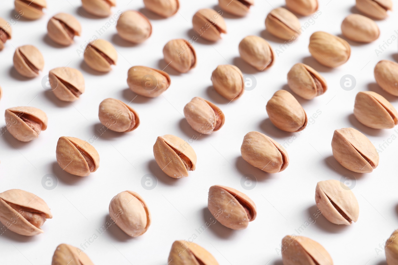 Photo of Organic pistachio nuts in shell on white background