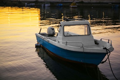 Photo of Beautiful view of river with moored boat at sunset
