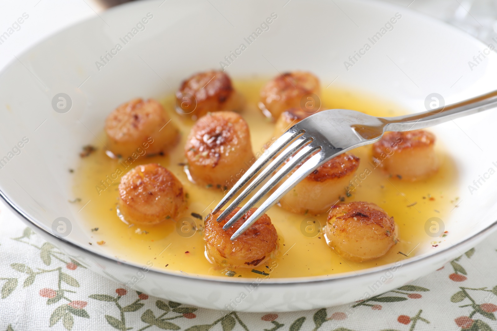 Photo of Delicious fried scallops served on white table