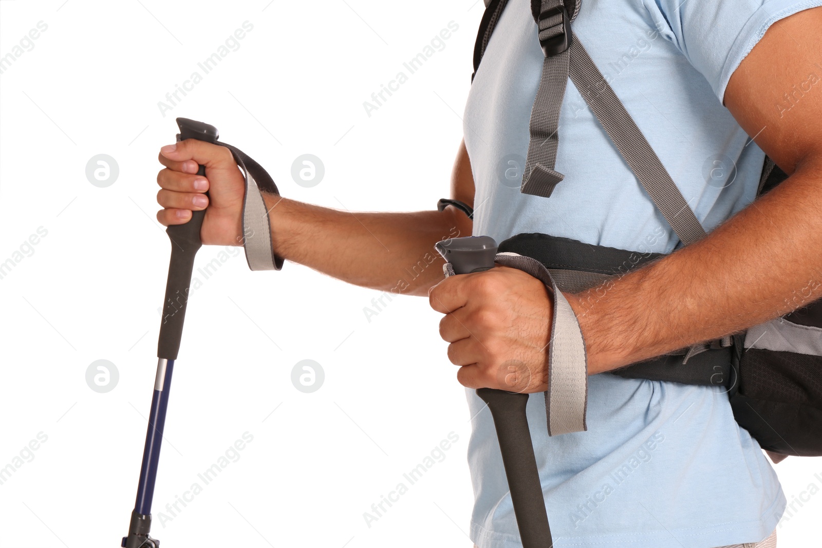 Photo of Male hiker with backpack and trekking poles on white background, closeup