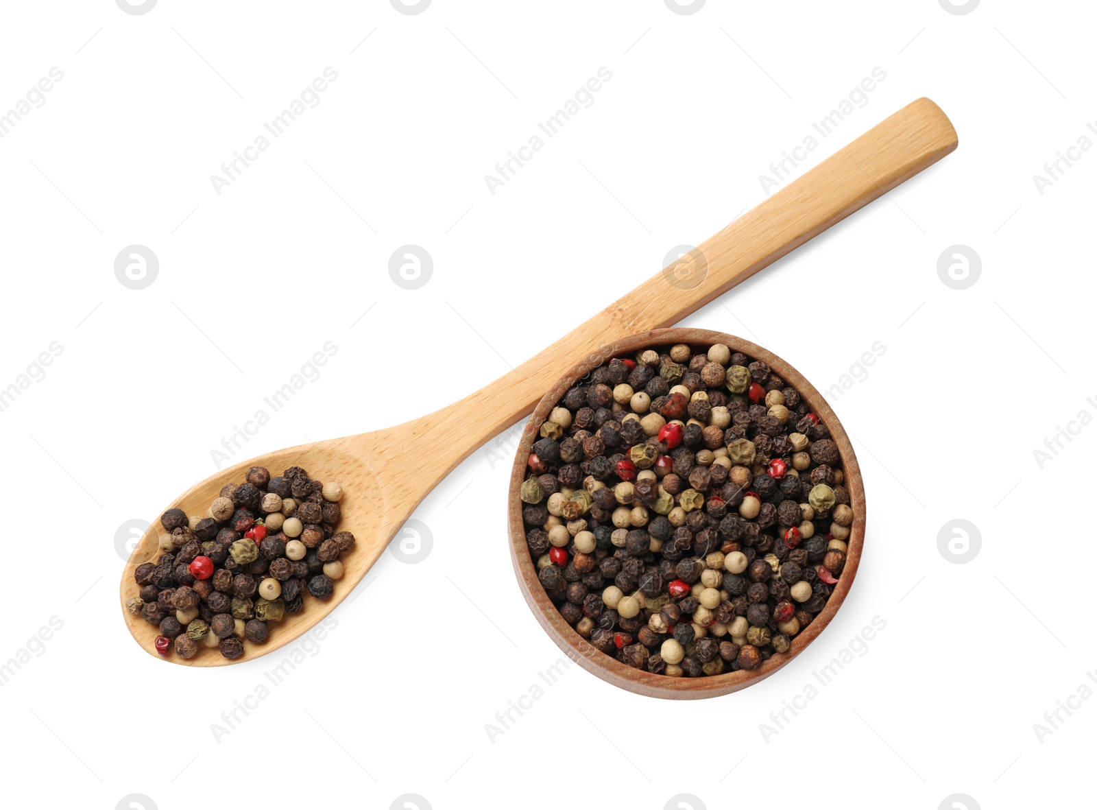 Photo of Aromatic spices. Different peppers in wooden spoon and bowl isolated on white, top view