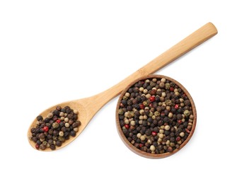 Photo of Aromatic spices. Different peppers in wooden spoon and bowl isolated on white, top view