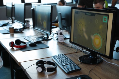 Photo of Tables with computers in internet cafe. Video game tournament