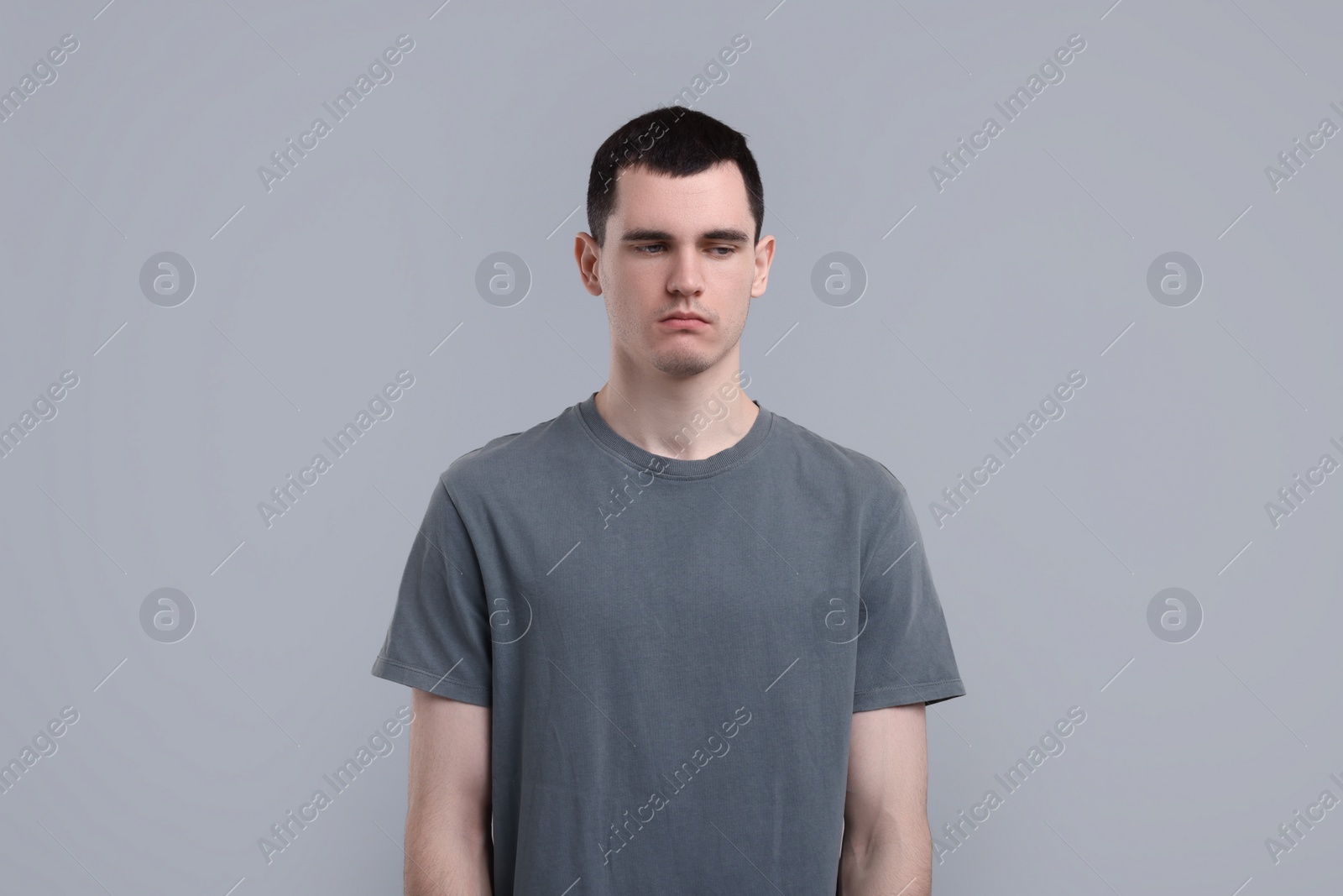 Photo of Portrait of sad man on grey background
