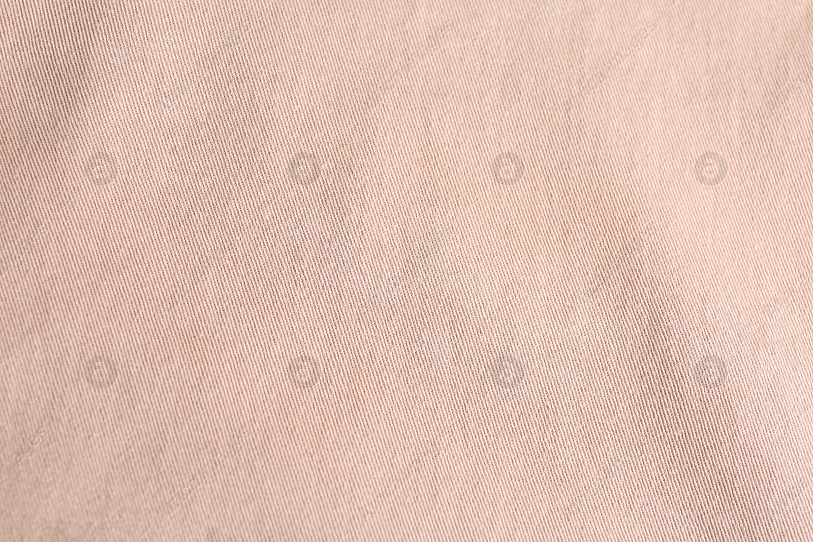 Photo of Texture of light pink fabric as background, closeup