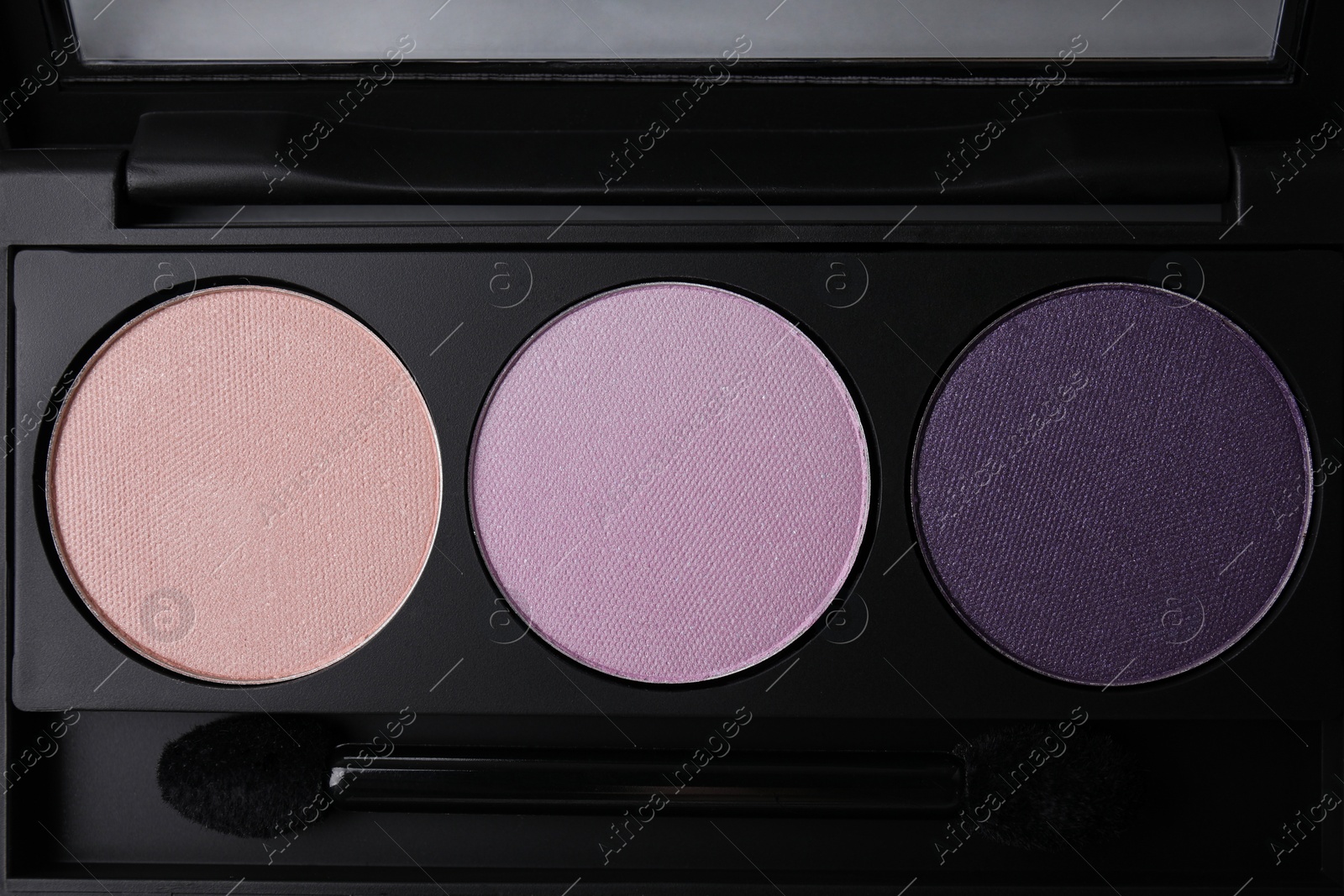 Photo of Beautiful eyeshadow palette as background, top view. Professional cosmetic product