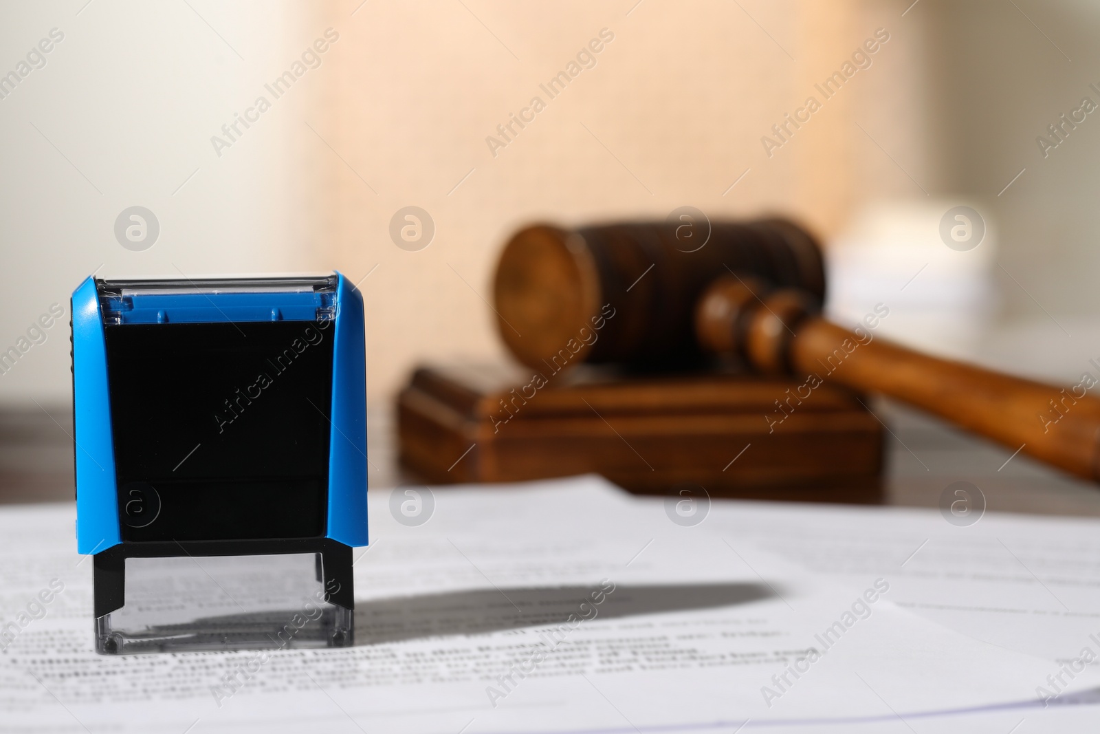 Photo of Notary contract. Stamp, documents and gavel on table