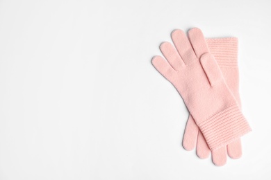 Photo of Stylish pink gloves on white background, top view with space for text. Autumn clothes