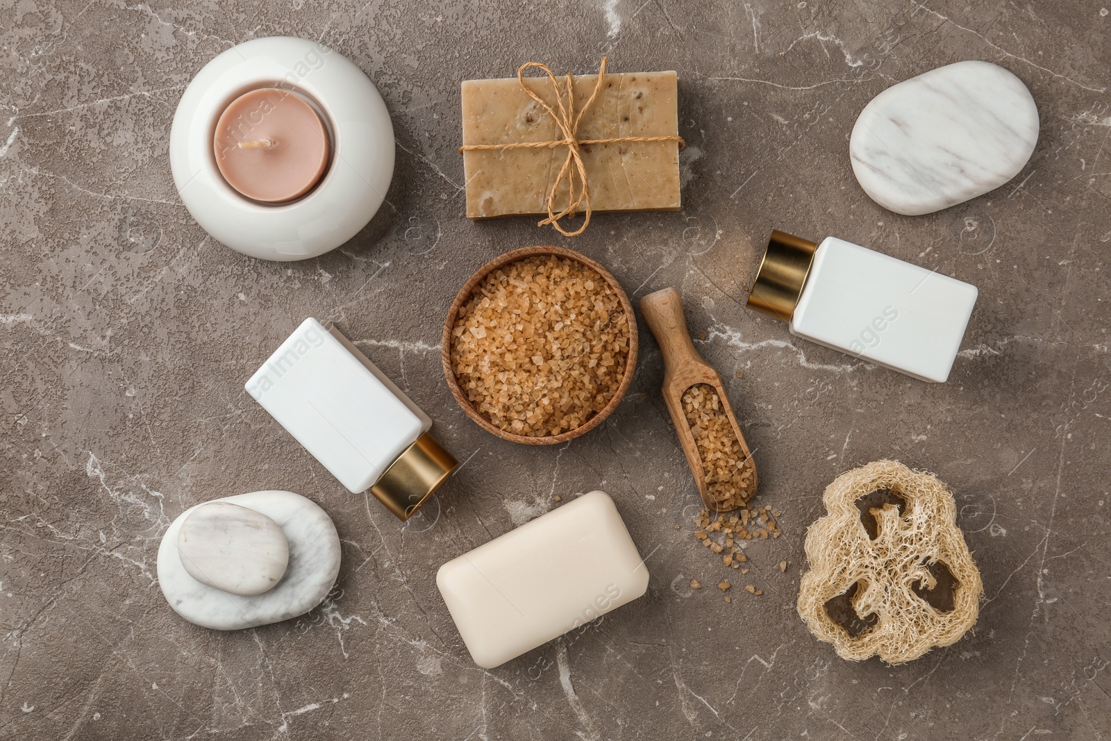 Photo of Flat lay composition with spa supplies on stone table