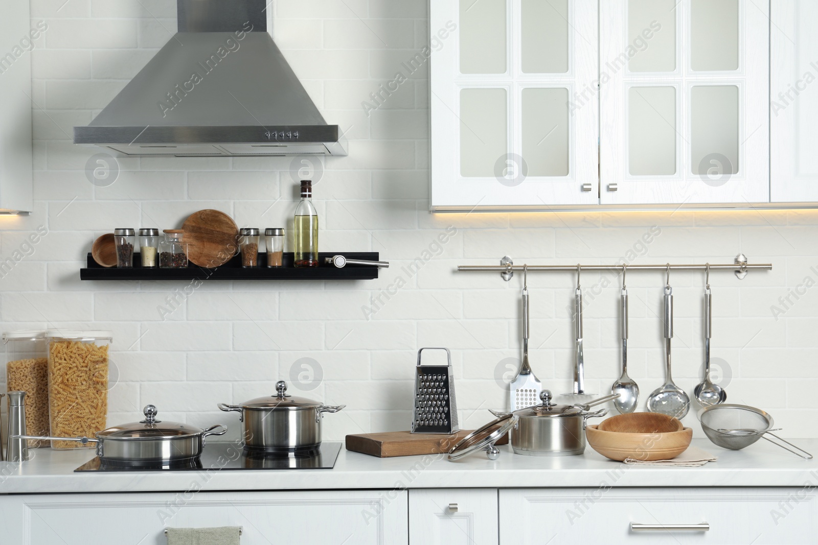 Photo of Countertop with different cooking utensils in kitchen