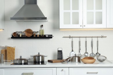 Photo of Countertop with different cooking utensils in kitchen