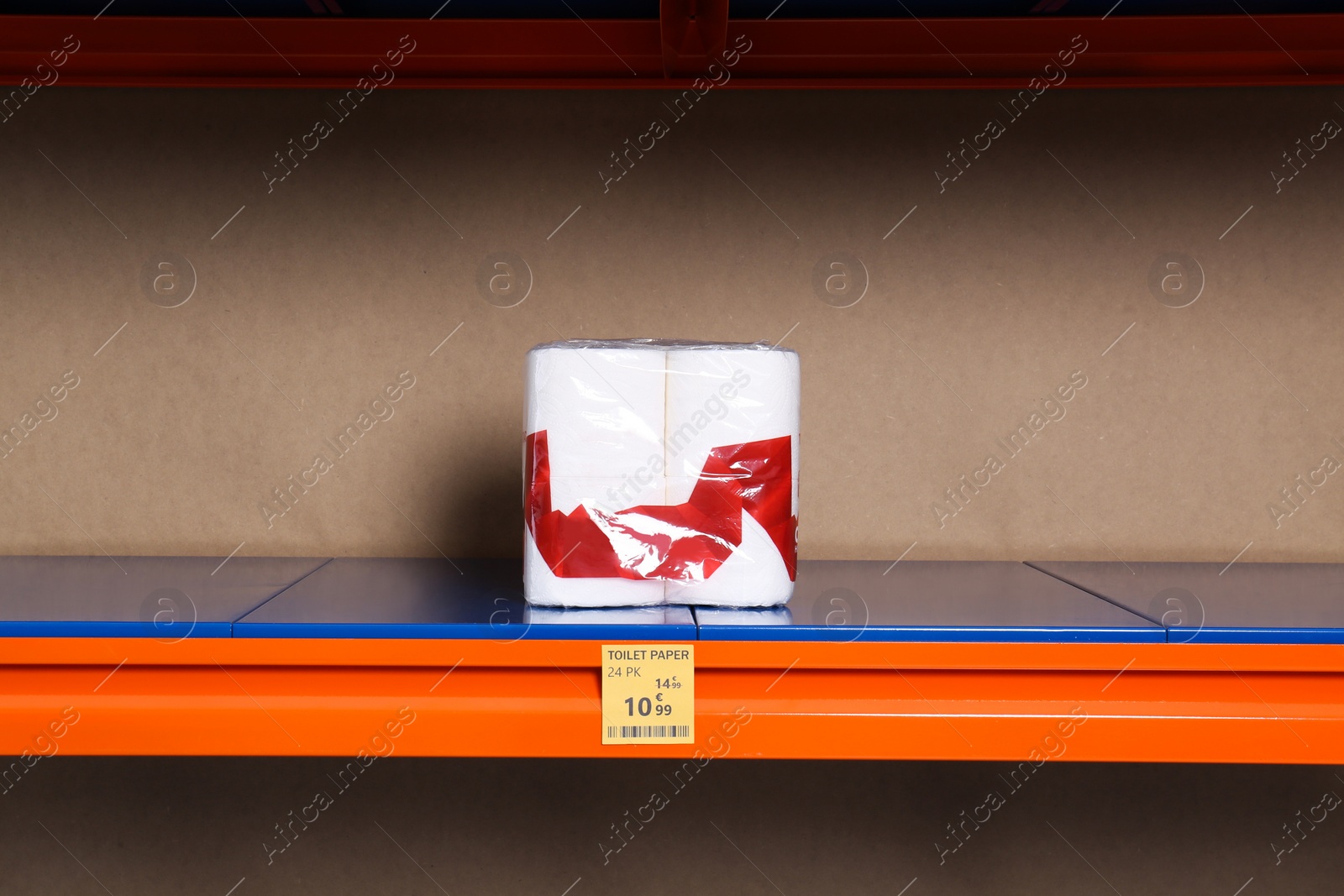 Photo of Pack of toilet paper on empty shelves. Product deficiency due to social panic