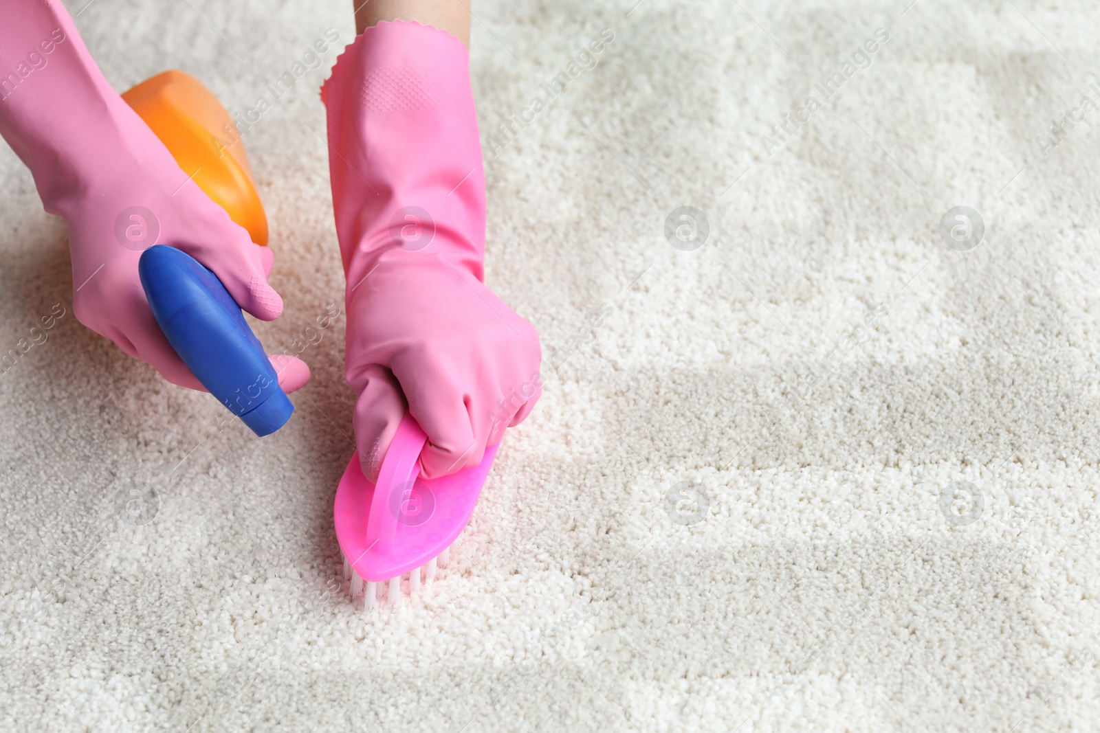 Photo of Woman cleaning carpet indoors