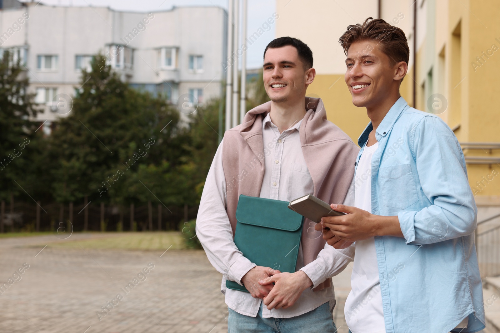 Photo of Happy young students outdoors, space for text