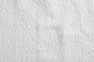 Photo of Texture of soft white towel as background, top view