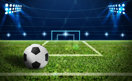 Image of Soccer ball on green football field, space for text 