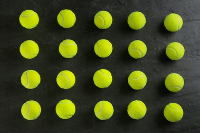 Tennis balls on black background, flat lay. Sports equipment