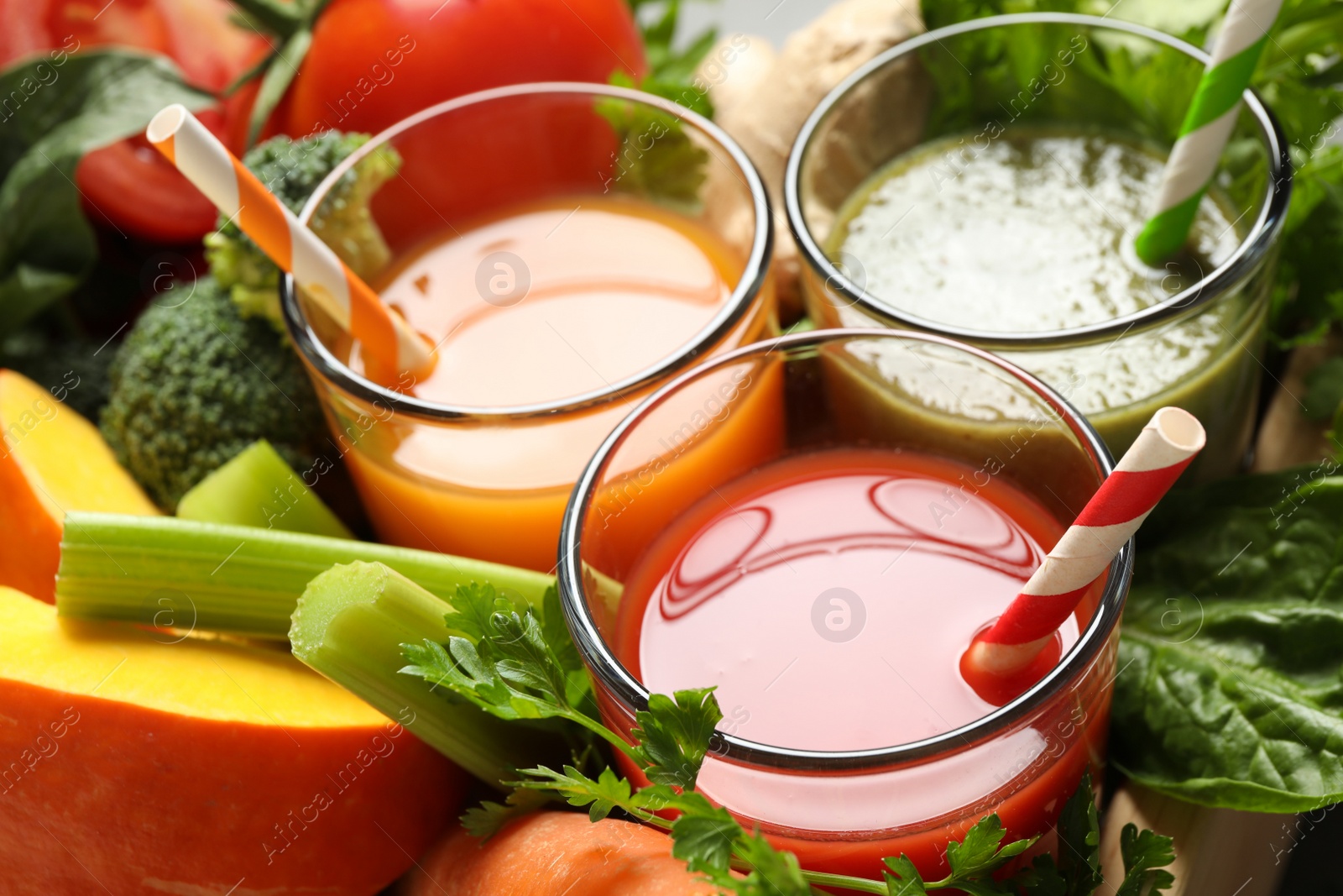 Photo of Delicious vegetable juices and fresh ingredients, closeup view
