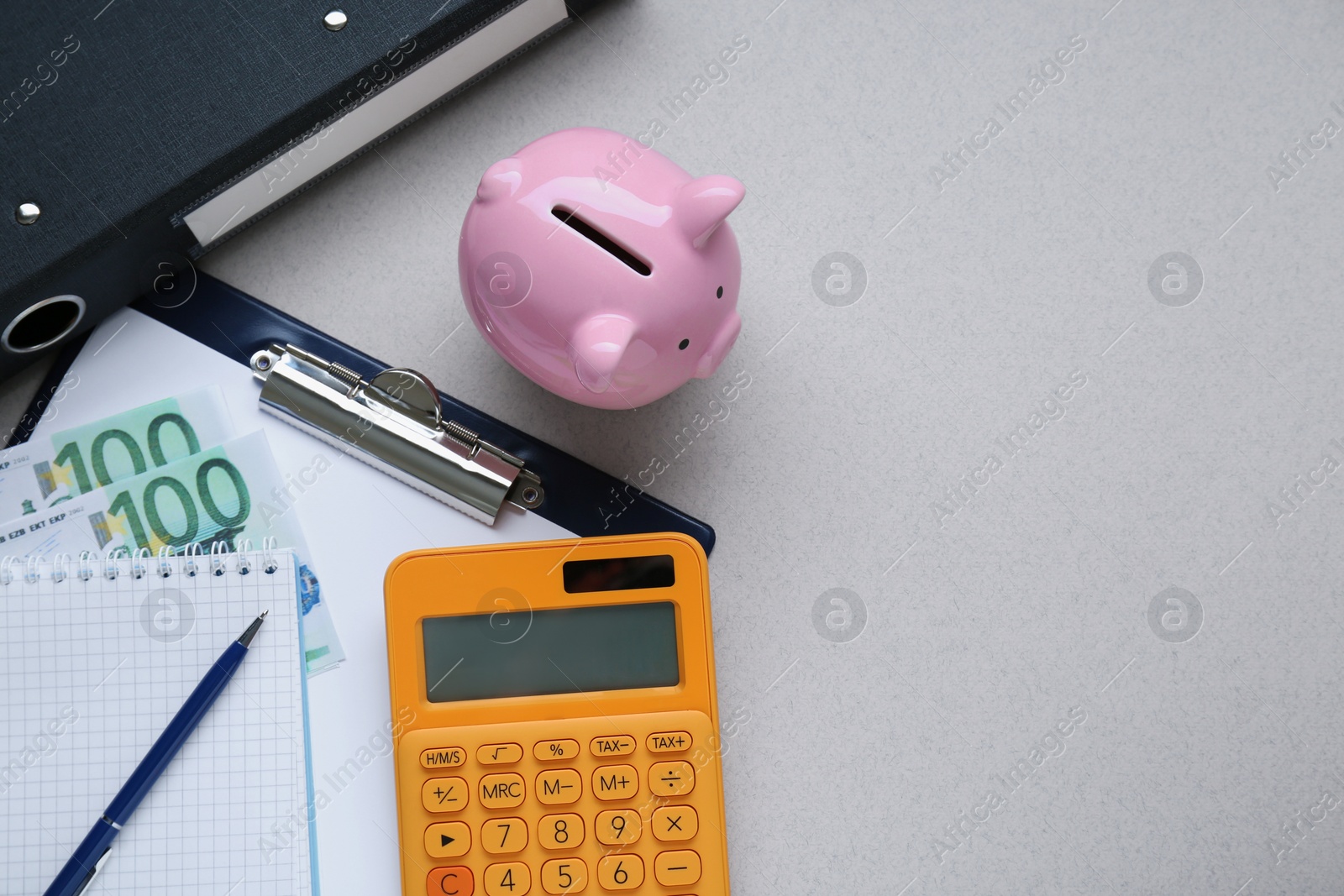 Photo of Flat lay composition with piggy bank, calculator and banknotes on grey background. Space for text