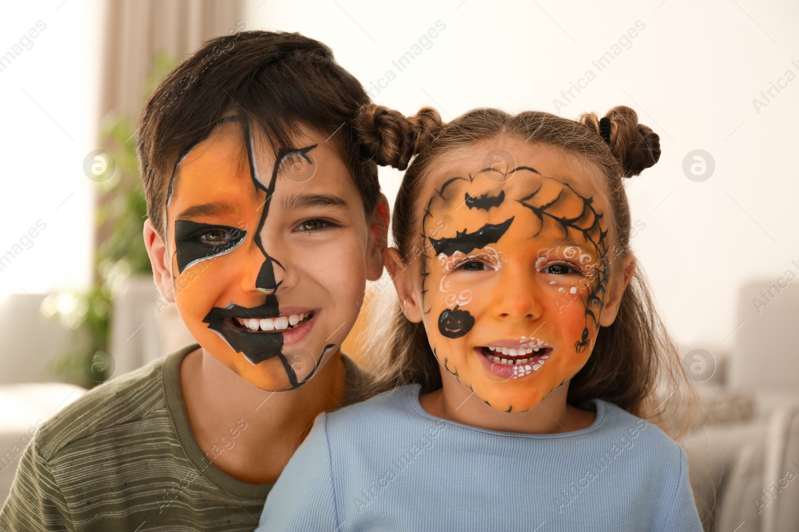 Photo of Cute little children with face painting indoors