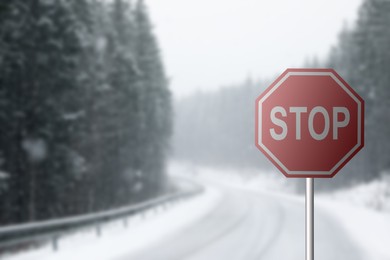 Highway with road Stop sign on snowy day, space for text