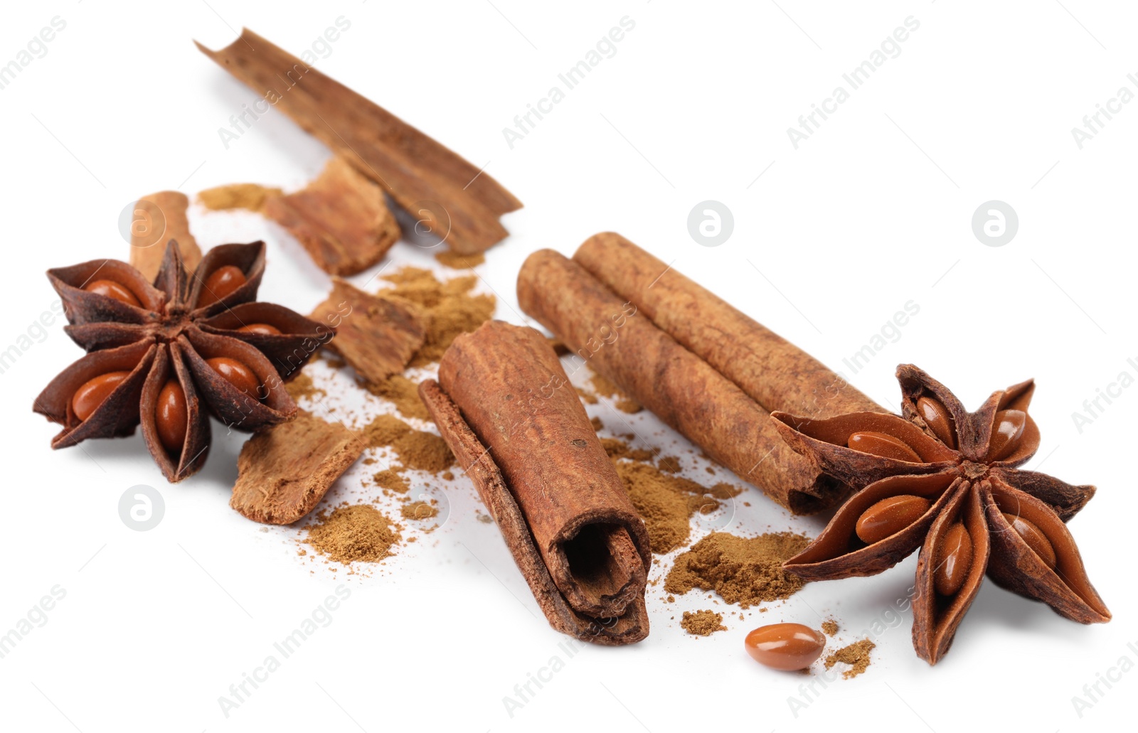 Photo of Dry aromatic cinnamon sticks, powder and anise stars isolated on white