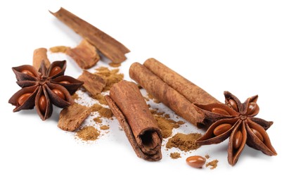 Dry aromatic cinnamon sticks, powder and anise stars isolated on white