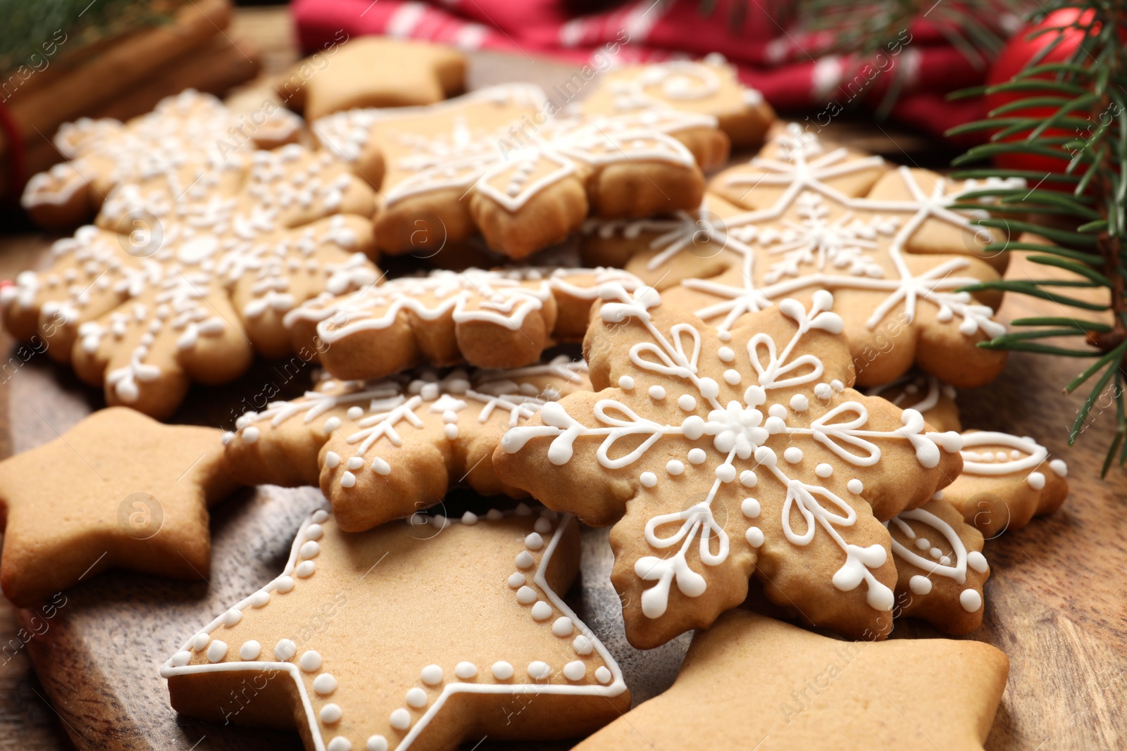 Photo of Tasty Christmas cookies on wooden table, closeup