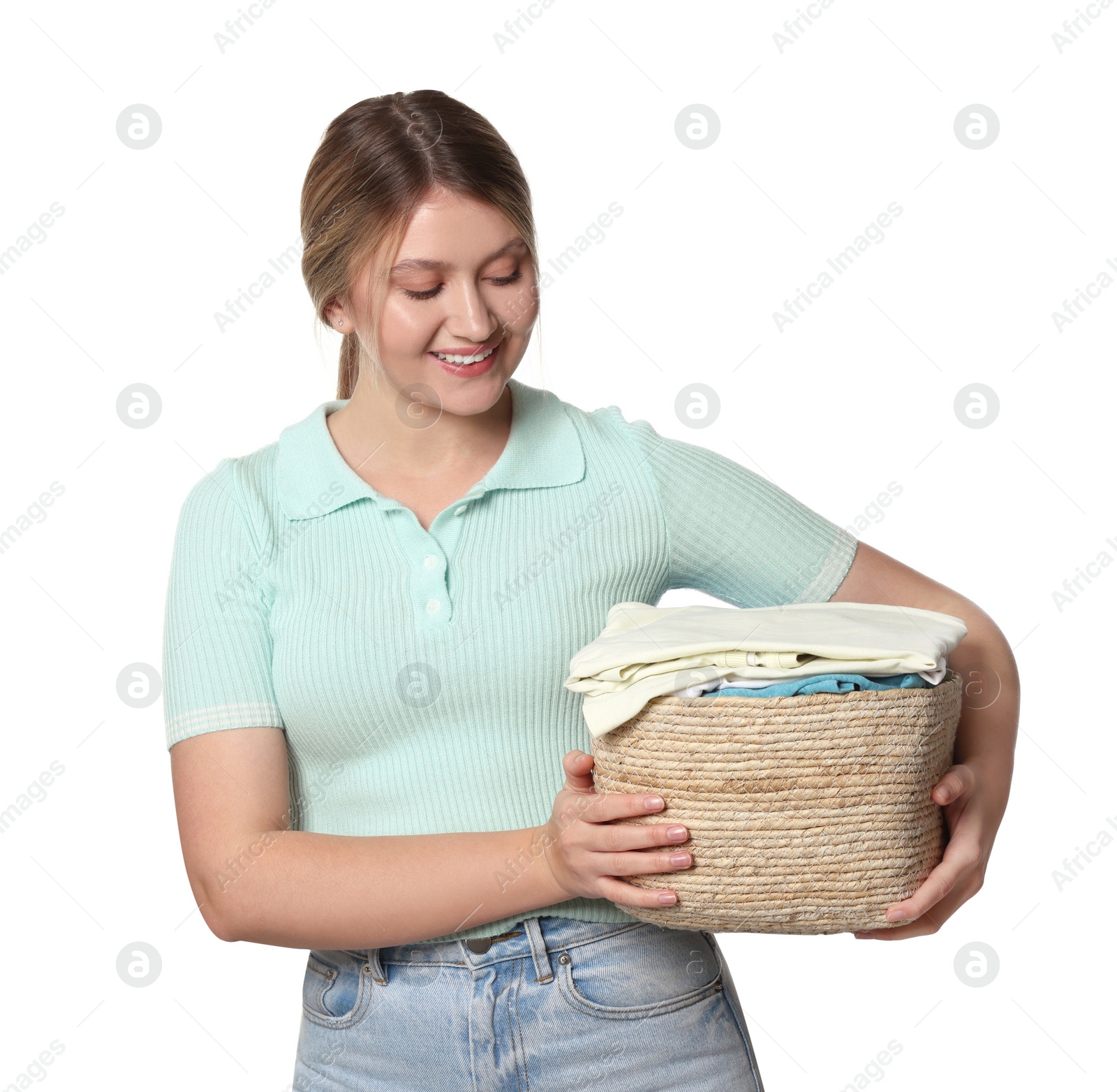 Photo of Happy woman with basket full of laundry on white background