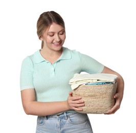 Happy woman with basket full of laundry on white background