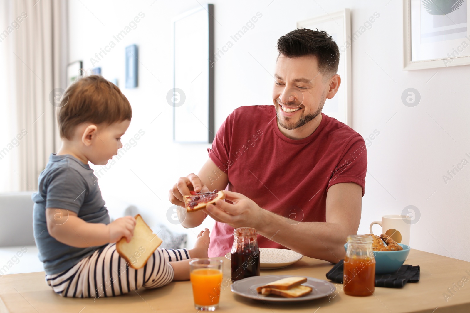 Photo of Dad and his son having breakfast in kitchen