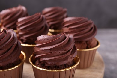 Photo of Delicious chocolate cupcakes on grey table, closeup